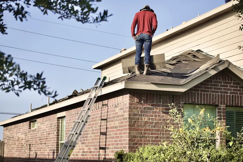 Professional roofer working on a residential roof in Water View